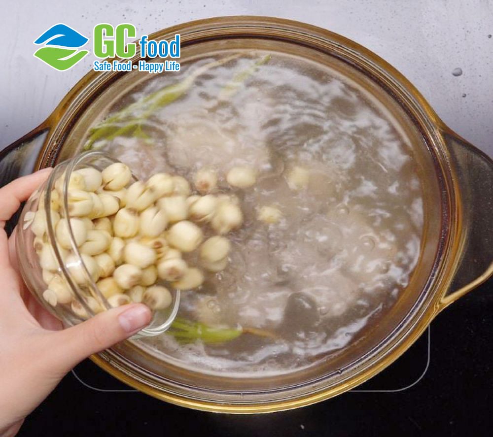 Simmer the lotus seeds over medium heat until they become tender.